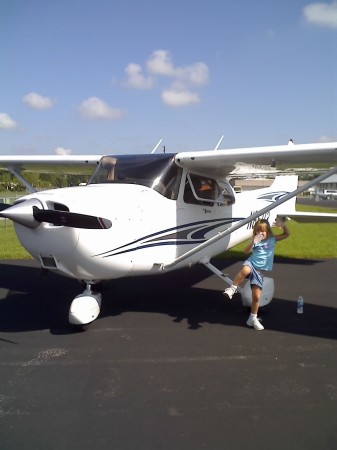 Baylee next to the plane I normally fly
