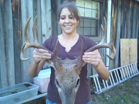 my daughter holding 14 point buck