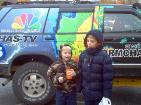 posing by storm chasing vehicle