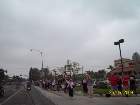 Some of the crowd gathered along the road