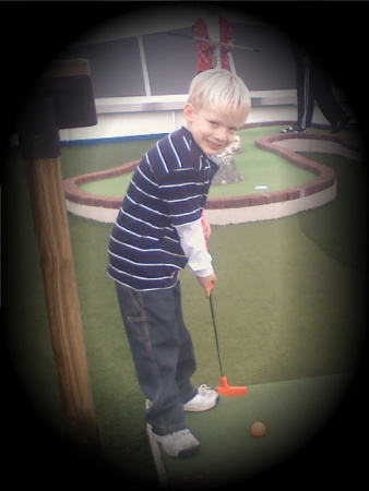 Christopher golfing on the ship