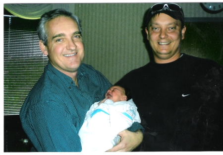 John holding Lewie's son after birth.