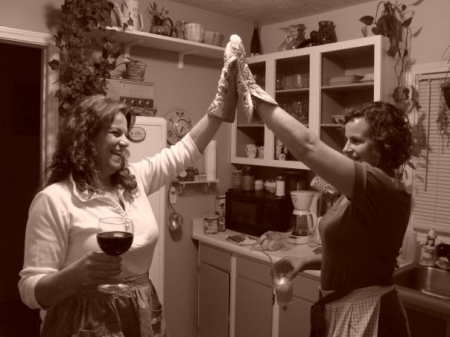 Mom and daughter stick the bird in the oven