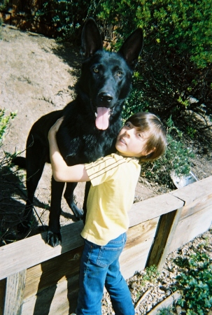 My youngest son w/our black AKC GSD pup