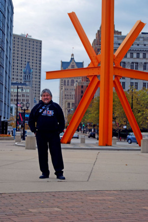 Standing in front of an abstract art piece