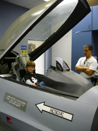 Logan in a F-22 flight simulator
