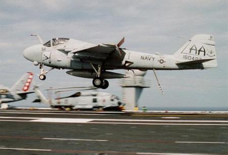 A6 jet landing aboard aircraft carrier