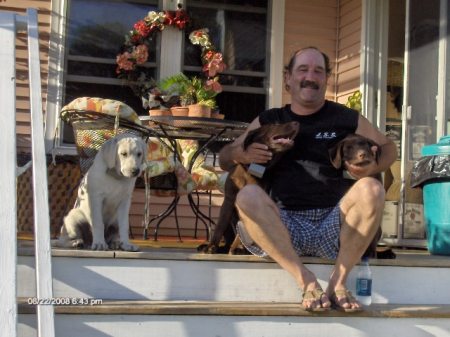 Scott and puppies on porch.