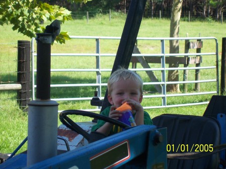 Ethan on one of our tractors