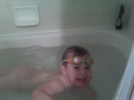 Charlie swimming in the bathtub