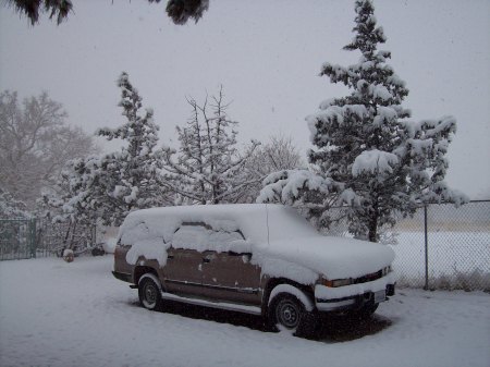 snow in the front yard covering the suburban