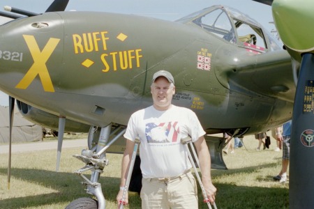 I in front of a P-38 with a broken leg.