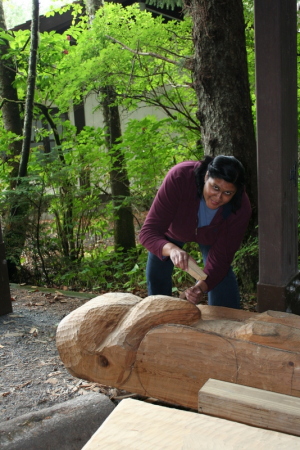 Annette carving a totem pole