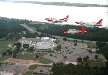 air to air formation with museum in background