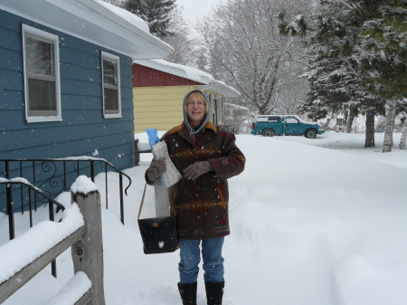 My wife in front of our home