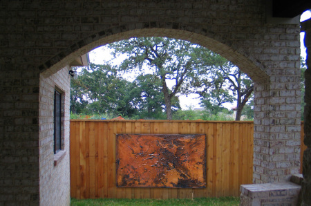 Yard art in wooden fence