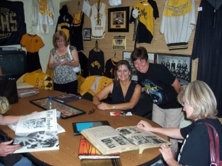 Karen H, Ellen, Debbie looking at yearbooks