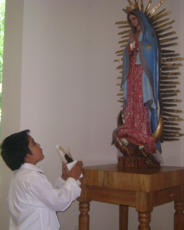 Sammy praying to the Virgin de Guadalupe