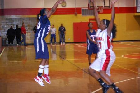 VaShonda in the air with a smooth 3-pointer