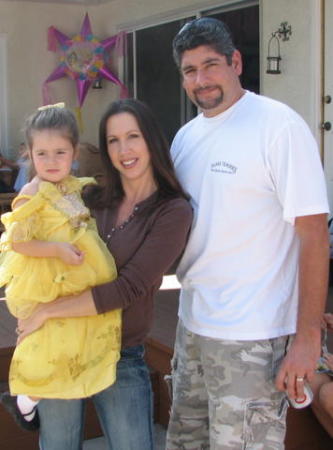 Me with my husband John and daughter Liliana at a princess party 2006