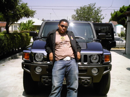 My son Lynn leaning on a Hummer