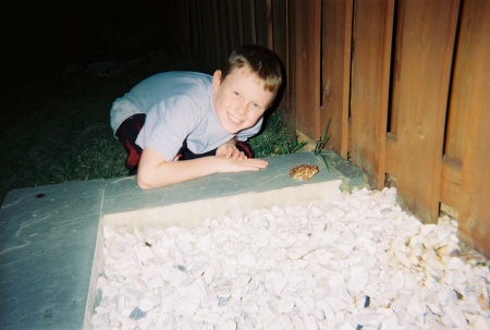 My son.  We found a toad living under the rocks in our backyard.