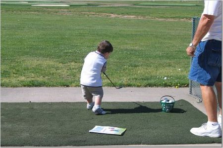 Robbie at 24 months swinging a golf club at the driving range