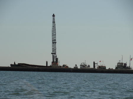 A barge with tug just outside the breakwater