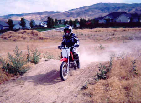 Mikala riding by the house