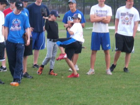 Alec (10) throwing out a pitch at camp.