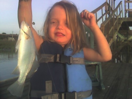 Ashley catching fish off our dock.