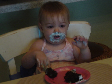 Shelby smashing her 1 year birthday cupcake