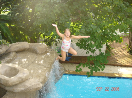 Paige jumping into our pool from the waterfall