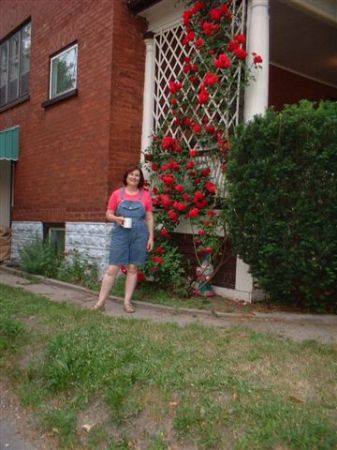 Michelle beside her climbing rose bush