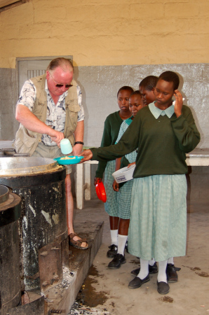 Me dishing out food in school in Kenya (2005)