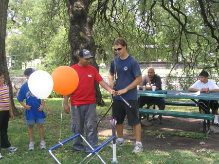 My son trying to shoot an arrow.