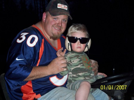 Joshua helping daddy mow