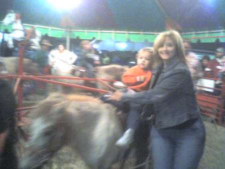 Logan riding a pony and NeNe holding him on!