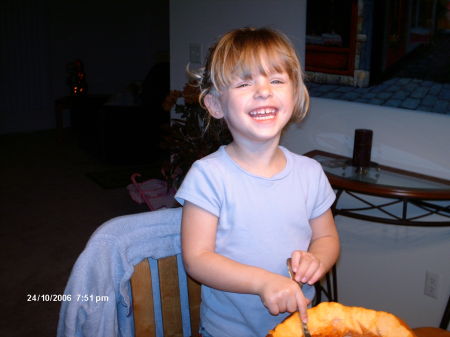 Abbie carving her pumpkin