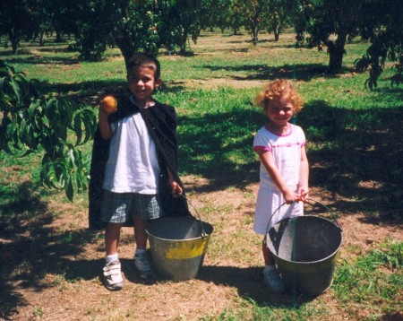 Tyler and Emily picking peaches