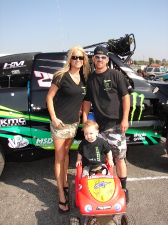 My wife, Me and my son in front of our teams race truck