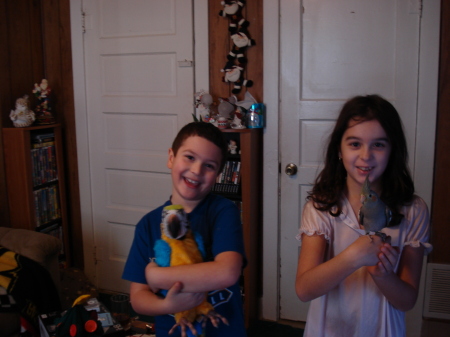 Caitlyn, Jacob and the birds Zoey and the fake parrot Christmas morning