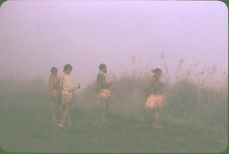 Young women playing flutes at dawn, New Guinea Highlands