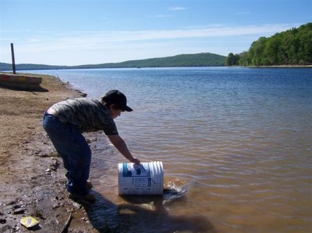 my son John stocking fish at Round Valley