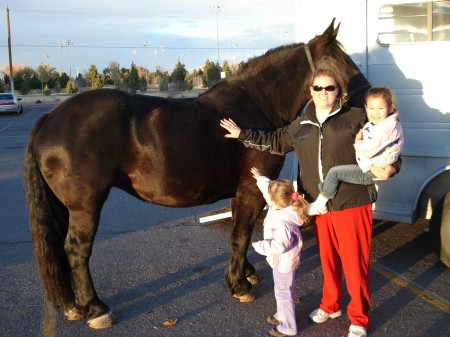 Girls and mommy petting a big horse!