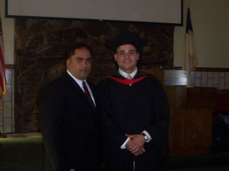 Our Pastor with my son when he qraduated.