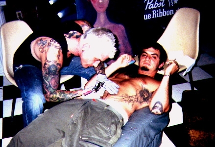 Ray Ray tattooing a friend from Florida.