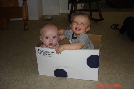 Mara and her cousin, Mason, in a box.