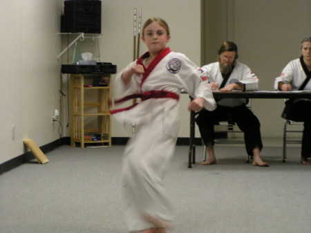 Riley Taking her test for Cho Dan Bo (Blue Belt) 2003