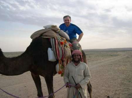 John on a camel in Saudi Arabia.